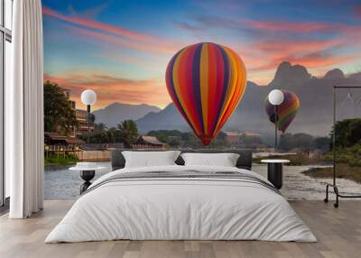 Nam Song river at sunset with hot air balloon in Vang Vieng, Laos, Beautifull landscape on the Nam Song River in Vang Vieng, Laos. Wall mural