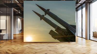 Two combat missiles aimed at the sky. Old ballistic missile launcher on blue sky background. Wall mural