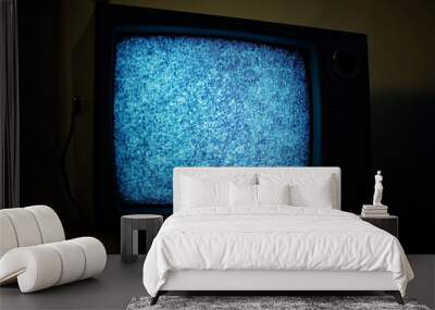 Old vintage television isolated on dark background with no signal and grainy noise Wall mural