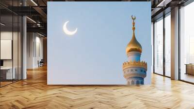 A beautiful mosque minaret topped with a golden crescent, set against a clear sky with a visible crescent moon, symbolizing Islamic culture and spirituality. Wall mural