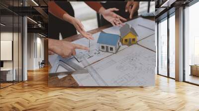 Group architects and engineers build houses and conference buildings together to design and build structures, sketch house plans to meet construction standards. Ideas for designing and building house. Wall mural