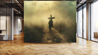 A lone figure carrying a heavy wooden cross on a dusty path  Wall mural