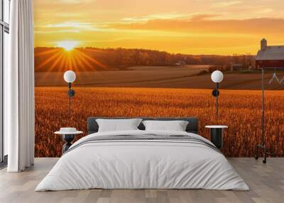 A stunning sunset over a golden field with a barn, capturing the beauty and tranquility of rural life. Wall mural