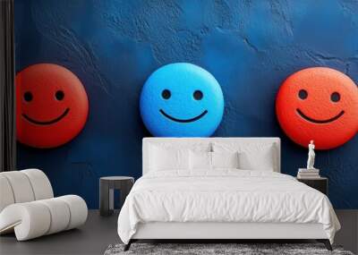 A vibrant composition of smiley faces in red and blue against a textured blue background, symbolizing positivity and emotions. Wall mural