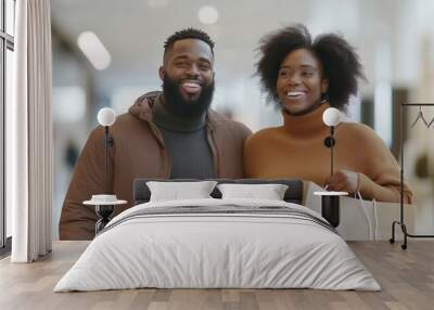 Happy couple smiling while shopping together in a modern mall setting. Wall mural