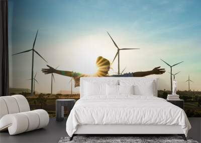 Wind turbines farm is an alternative electricity source, Concept of sustainable resources, Renewable energy concept, Girl standing and watching the sunset with wind generators turbines to backgrounds Wall mural