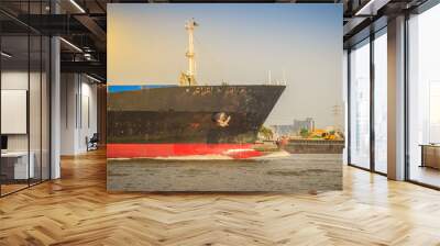 Massive container ship for import export and business logistic. Big cargo ship is leaving from Bangkok Port Authority of Thailand or Klong Toey port along Chao Phraya river in Bangkok,Thailand. Wall mural