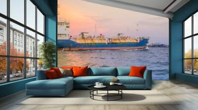 Massive container ship for import export and business logistic. Big cargo ship is leaving from Bangkok Port Authority of Thailand or Klong Toey port along Chao Phraya river in Bangkok,Thailand. Wall mural