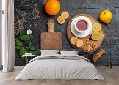 top view cup of tea with fruits and cookies on a dark desk ceremony sweet biscuits sugar Wall mural