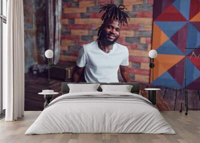 African American man with dreadlocks and a white T-shirt. Mock-up. Wall mural