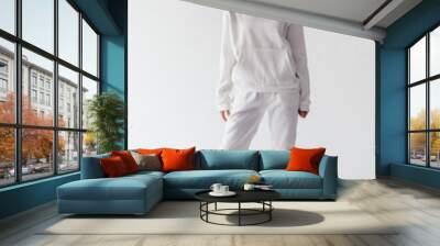 Attractive woman with thick curly hair in a white suit of hoodies and sweatpants. Mock-up. Wall mural