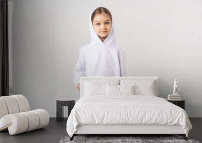 Cute little girl in white blank sweatshirt. Wall mural