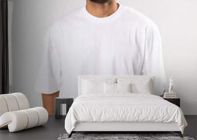 Stylish african american man in a white t-shirt stands a white background. Mock-up. Wall mural