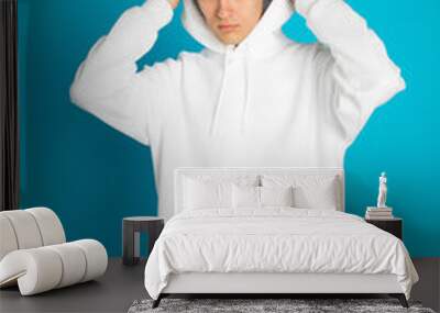 Young man in a white hoodie. Mock-up. Wall mural