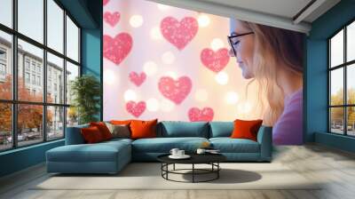 Joyful Girl with Heart-Shaped Balloons Chatting on Computer for a Romantic Date Planning Wall mural