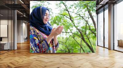 Shot of muslim woman standing , praying portrait. Wall mural