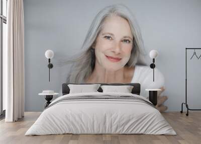 stunning beautiful and self confident best aged woman with grey hair smiling into camera Wall mural