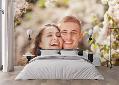 Young couple having fun in a sunny park in springtime, beautiful, romantic mood Wall mural