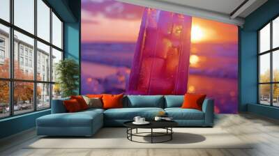 A close-up of a popsicle with a gradient of colors, from deep purple to light pink, held against a backdrop of a sunset. The vibrant colors and beautiful background create a visually stunning image. Wall mural