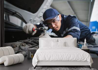 a uniformed maintenance technician is working on a vehicle inspection service. vehicle repair and ma Wall mural