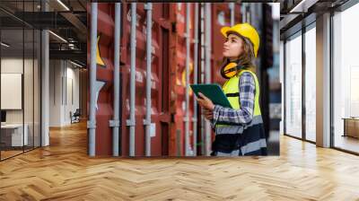 Beautiful female worker working in a safety suit at a port warehouse. Security check in port warehouse. Transport, import, export. Logistics concept. Industry. Wall mural