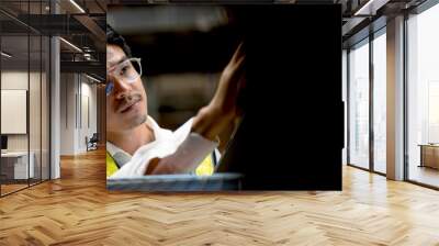 Handsome male worker checking stock in  warehouse. with a digital tablet. Warehousing and logistics concepts. Close-up photo. Banner image. Wall mural