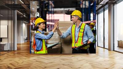 Two engineers taking notes using tablets in a large industrial warehouse. Workers in safety clothing inspect equipment in warehouses for authenticity, manufacturing and export industry concepts. Wall mural