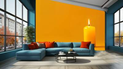 Single candle with copy space on yellow background Wall mural