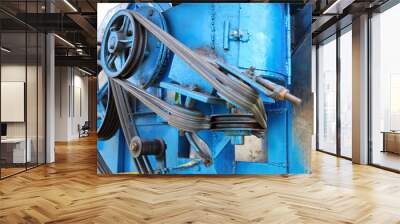 close up pulley and belt. transmission belt with multiple pulleys on a blue combine harvester backgr Wall mural