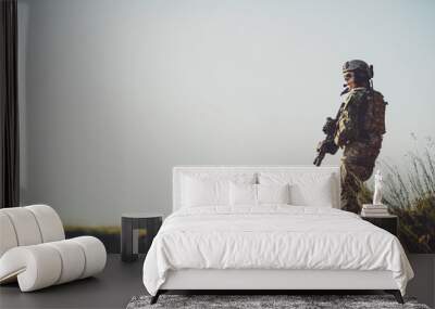 military soldier with weapons at sunset. shot, holding gun, colorful sky. military concept. Wall mural