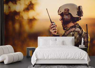 military soldier with weapons at sunset. shot, holding gun, colorful sky. military concept. Wall mural