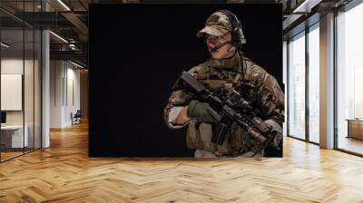 Portrait soldier or private military contractor holding sniper rifle. war, army, weapon, technology and people concept. Image on a black background. Wall mural