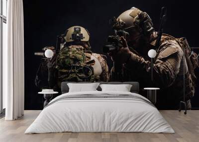 soldiers or private military contractors holding rifle. Image on a black background. war, army, weapon, technology and people concept Wall mural