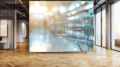 A close-up of an empty shopping cart in a bright grocery store aisle, showcasing modern retail shopping ambiance. Wall mural