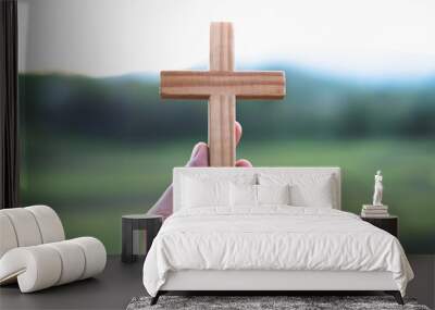 Holding the cross, the symbol of the blessing of Jesus, the symbol of supplication and faith, the symbol of the cross with a pure nature. Wall mural