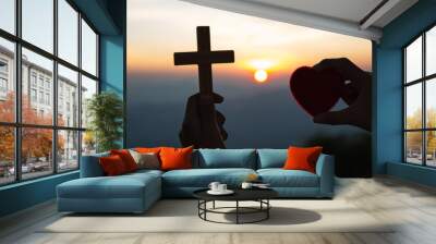 Holding the heart and the cross, the symbol of Jesus' blessing, the symbol of supplication and faith, the symbol of the cross in the sky in the sky There is a space to enter text. Wall mural