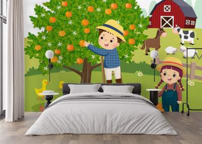 Vector illustration cartoon of little boy and little girl picking oranges in the farm. Wall mural