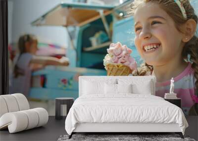 A happy and smiling white girl is holding an ice-cream cone in front of a food truck. The kid is holding a strawberry soft serve ice-cream cone. Wall mural