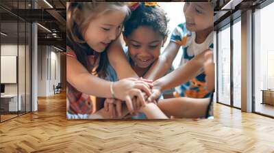 Close-up of 5 black and white children in diversity gender, skin color and nationality are playing by put their hands together to combine power in a classroom background.  Wall mural