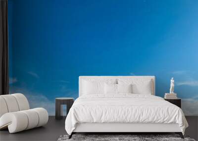 The expanse of a clear sky adorned with gracefully streaked clouds on a fine day Wall mural