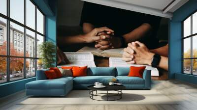 Christian group are praying to god with the bible and sharing the gospel. Concept of faith for god. Wall mural