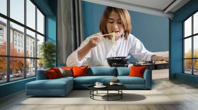 woman sitting at chair enjoy eating delicious set box food having takeaway at home relaxing resting and happy lifestyle concepts Wall mural