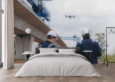 Engineer surveyor team Use drone for operator inspecting and survey construction site. Surveyors or explorer use drones to view construction sites or check security Wall mural