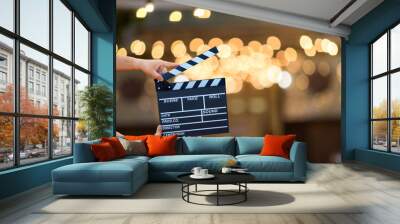 Man hands holding movie clapper. Film director concept. camera show viewfinder image catch motion in interview or broadcast wedding ceremony, catch feeling, woman hand hold a Film Slate over bokeh Wall mural