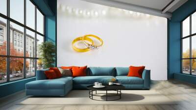 two diamond wedding rings for groom and bride with pearl necklace on white background, symbol of wedding, love and valentine. sign of couple live. image for background,wallpaper and copy space. Wall mural