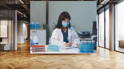 Group of dedicated scientist conduct chemical experiment in medical laboratory, carefully drop precise amount of liquid from pipette into test tube for vaccine drug or antibiotic development. Neoteric Wall mural