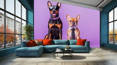 Two stylish dogs, one with sunglasses and the other in a tie, pose confidently against a vibrant purple backdrop. Wall mural