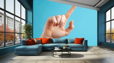 Man hand on blue background Wall mural