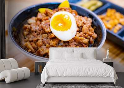 Taiwanese Minced pork rice with an egg and pickled vegetables on wooden table and tray Wall mural