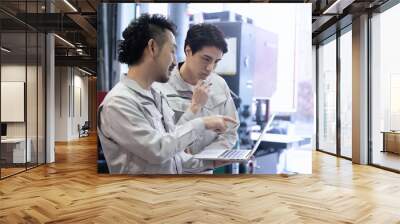 Workers checking processes and safety at a factory or job site while looking at a computer Copy space on the right Wall mural